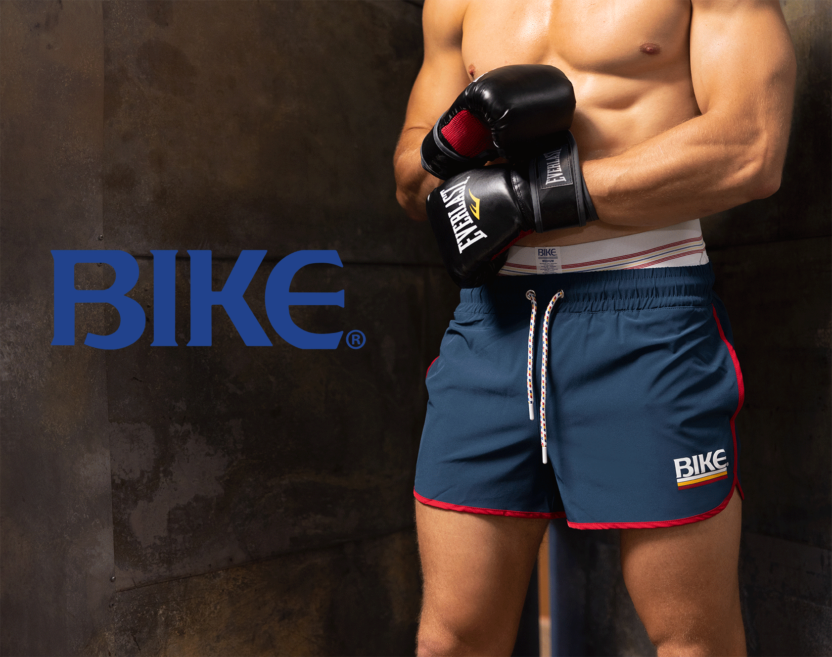 BIKE Athletic Apparel Portfolio Project – Digital Marketing Case Study Male model wearing BIKE brand athletic shorts and boxing gloves, representing the brand's athletic apparel for men.